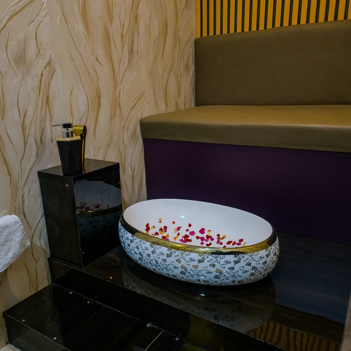 Decorated foot wash station with rose petals at Aurora International Spa
