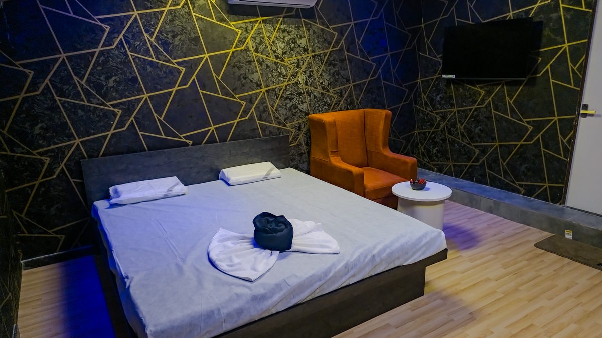 Private massage room with geometric gold wallpaper at Aurora International Spa