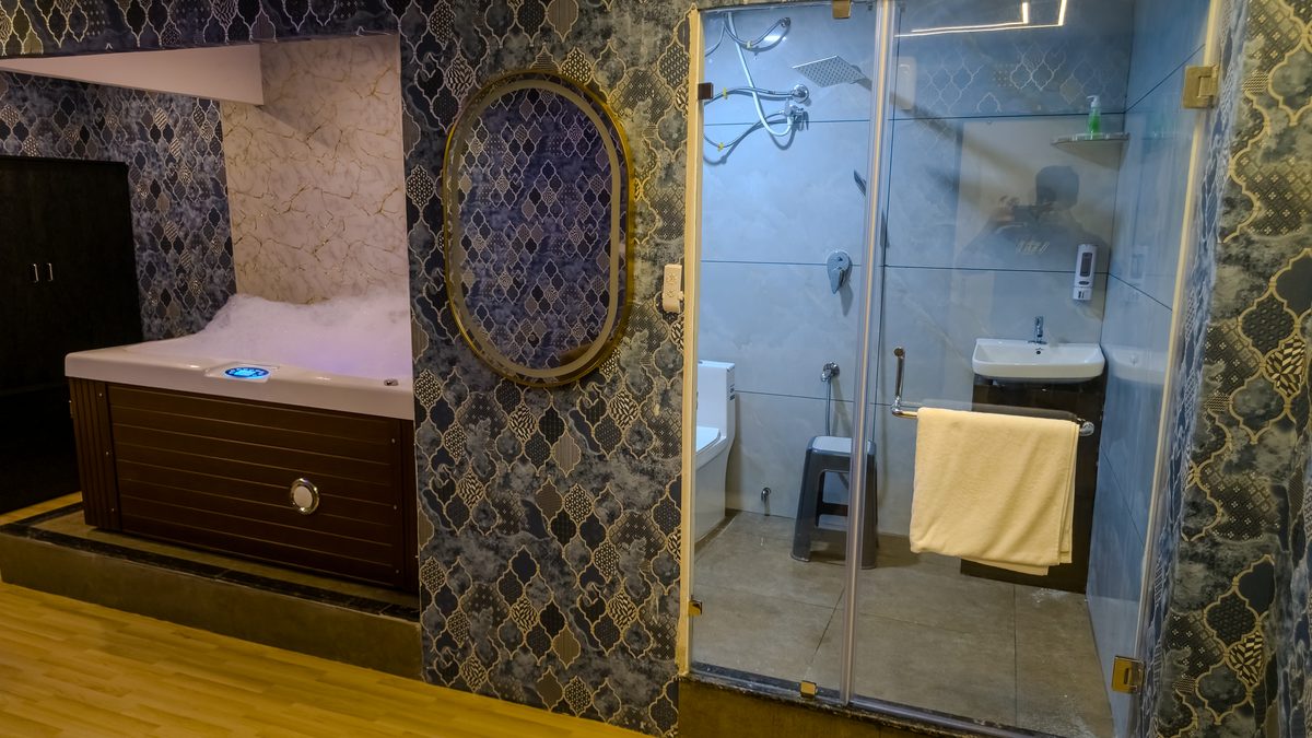 Glass-walled private shower room at Aurora International Spa